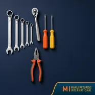 Unbranded wrenches, ratchet, screwdrivers and pliers laid out on navy, for a guide to top-rated hand tool brands